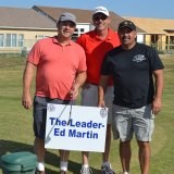 Jay Salyer, Ray Etchegoin and Ray Madrigal stand behind their favorite sign at the tourney